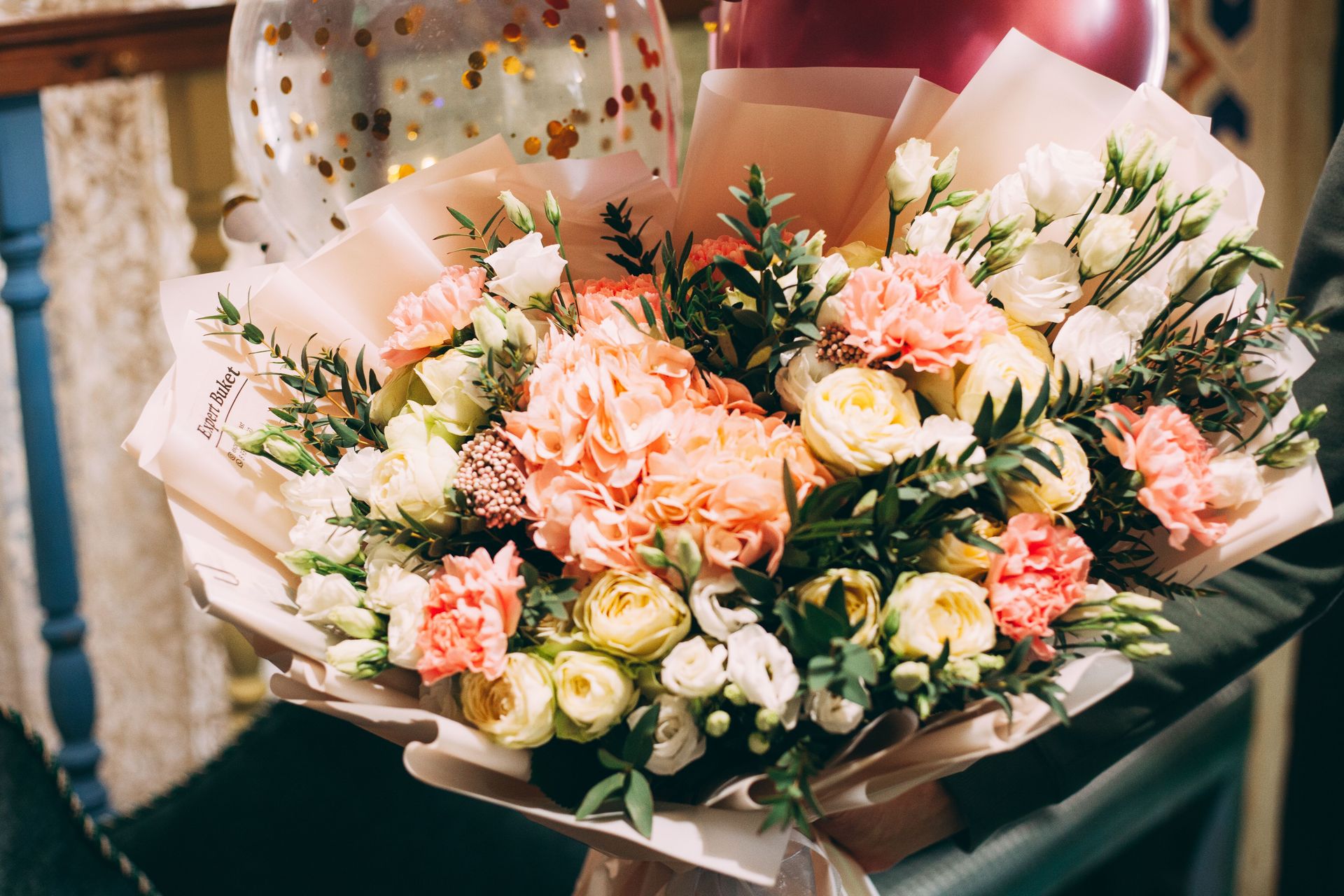 Beautiful close-up of a vibrant flower bouquet featuring roses and carnations, perfect for celebrations.